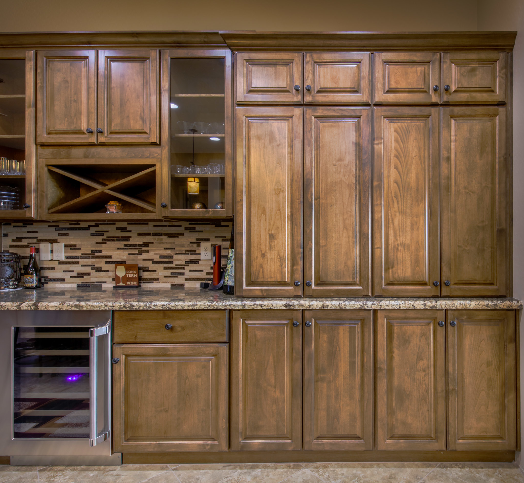 Custom pantry cabinets with wine rack and glass doors by Maverick Kitchens